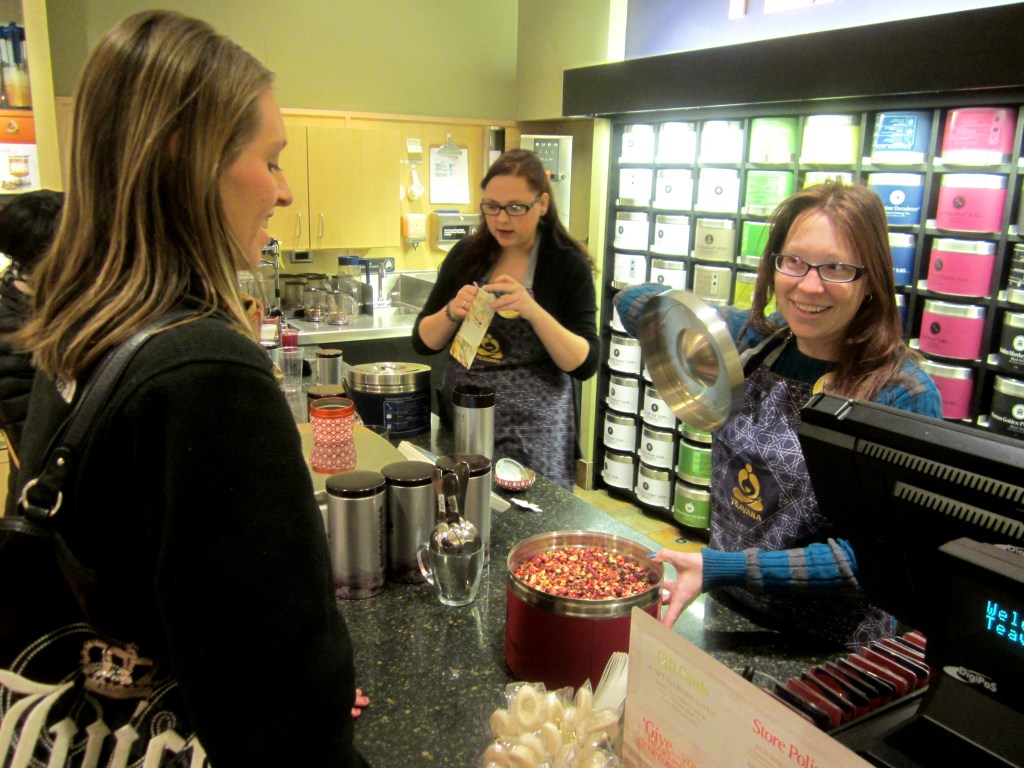 Teavana associate Lauren Delmonico, right, shows a customer the Wild Orange Blossom loose tea. PHOTO/STEPHANIE SOKOL