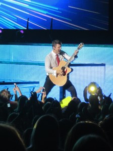 Nick Carter plays guitar during at DTE Energy Music Theater. STEPHANIE SOKOL/The Oakland Press