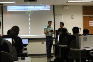 Photo/Stephanie Sokol Dominic Dabish demonstrates "Pong With Me" during one of Sebnem Onsay's programming courses.